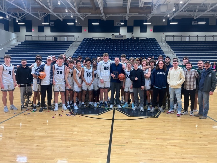 Men’s basketball team with alumni
